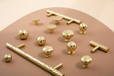 Nordic Gold Polished Hand Hammered Cabinet door handles and knobs.